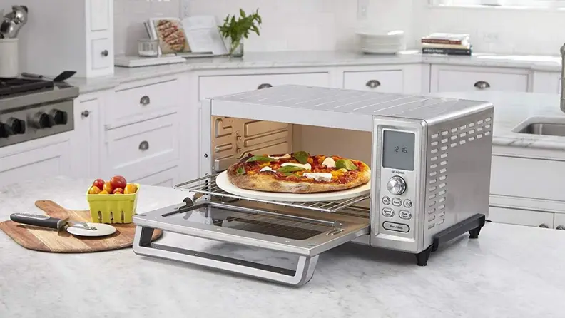 Cuisinart toaster oven on a kitchen counter with a pizza inside