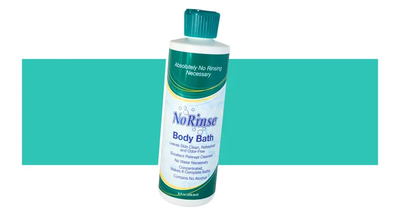 A can of No-Rinse Body Bath in front of a background.
