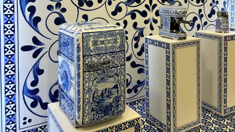 Three blue and white Smeg small appliances on a display.
