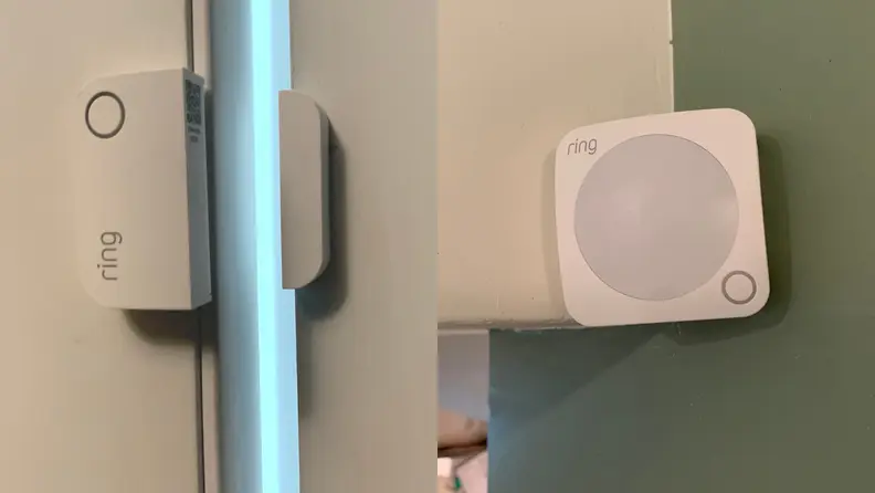 Ring sensors and motion detectors hang on a door and wall.
