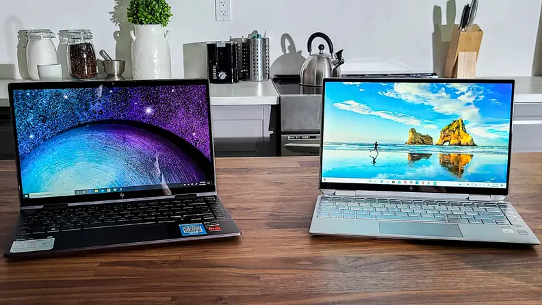 The HP Envy x360 besides the HP Spectre x360