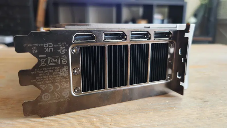 A close up of a metal plate on the back of a graphics card with connectivity ports.