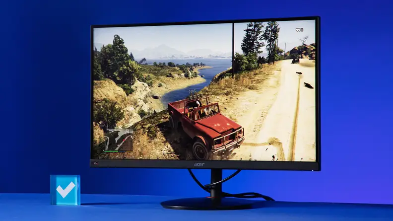 Desktop monitor on top of surface with animated game on screen.