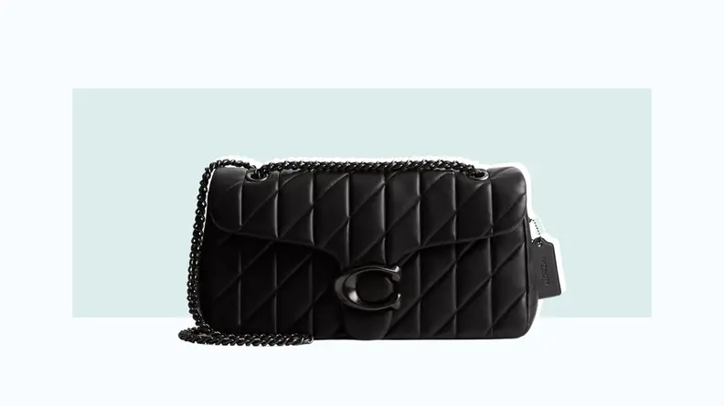 A black quilted leather bag with the Coach C-logo hardware and a chain strap.