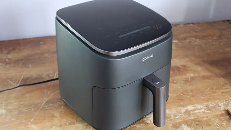 The Cosori TurboBlaze on a counter, with its touchscreen control panel visible.