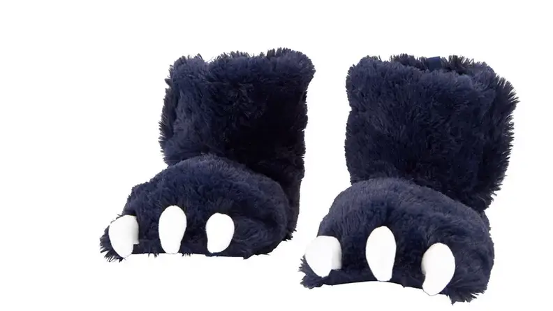 A pair of toddler slippers that look like dark purple dinosaur feet