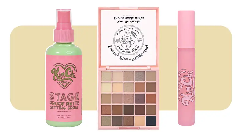 A spray bottle sits to the left of an eyeshadow palette and a pink mascara tube sits to the right.