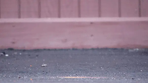Several padlocks falling from the sky and slamming into asphalt as part of a durability test