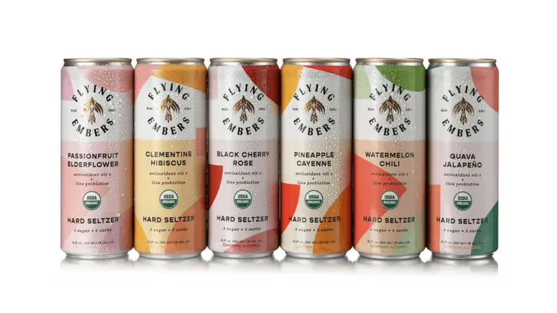 An assortment of colorful cans of hard seltzers on a white background.