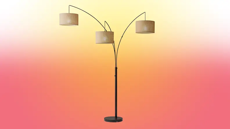 A lamp stands on a red and yellow fade background