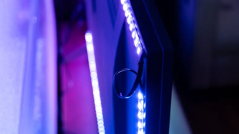 Purple LED Govee backlights being installed behind TV.