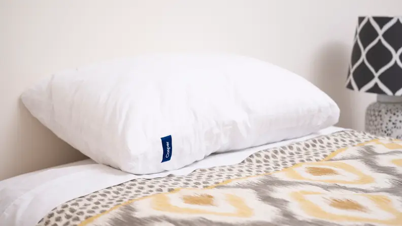 The Casper Original pillow in a yellow bedspread