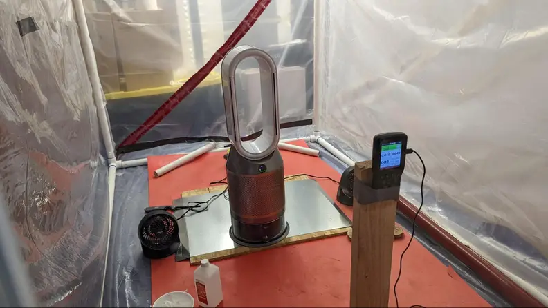 An air purifier is put to the test inside a lab.