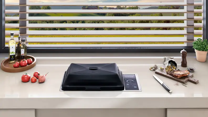 A kitchen counter with Kenyon countertop grill built in