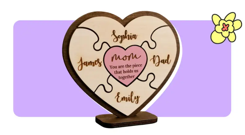 A carved wood plaque into the shape of a heart with puzzle pieces inside in front of purple background with a yellow cartoon flower in the corner.