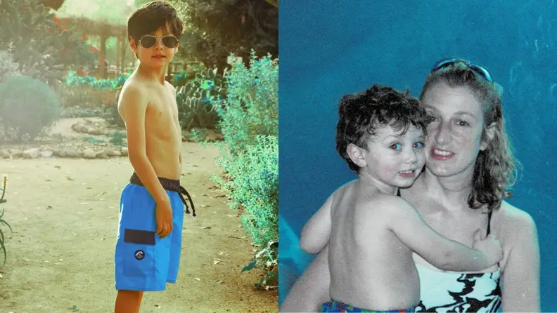 A boy in swim trunks and a mother holding her child