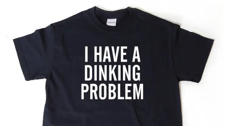 Black shirt that reads "i have a dinking problem" in white text