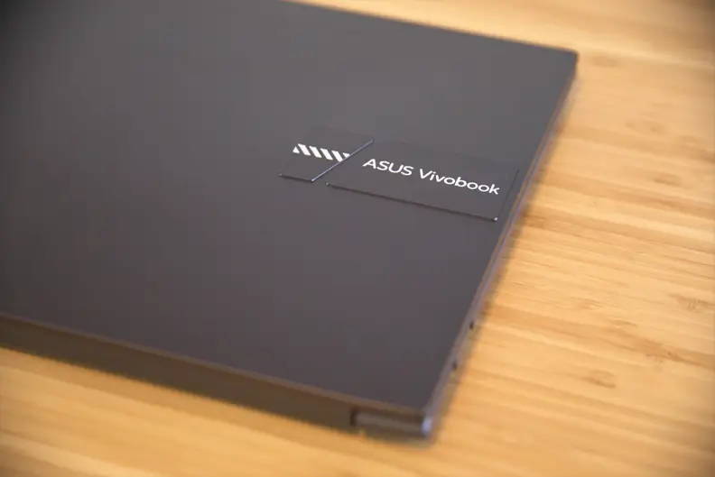 A close-up of a logo on top of a closed laptop