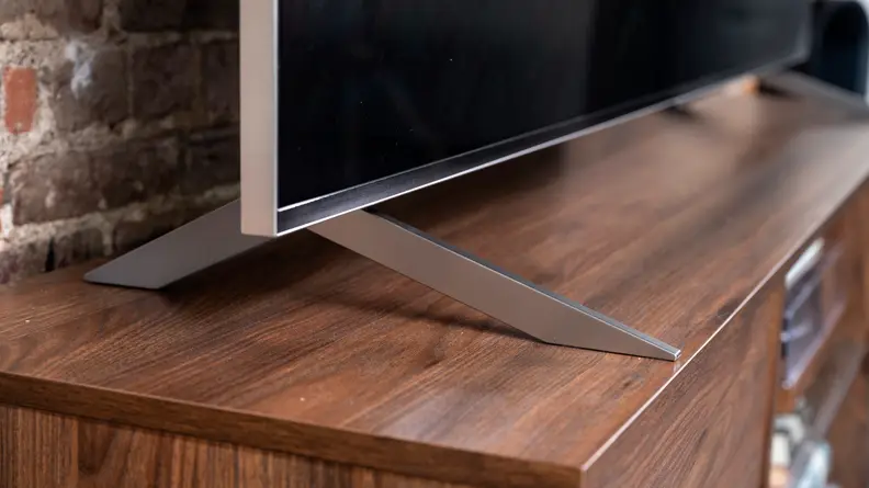 A close-up of the feet that act as a stand for the LG QNED99 8K TV