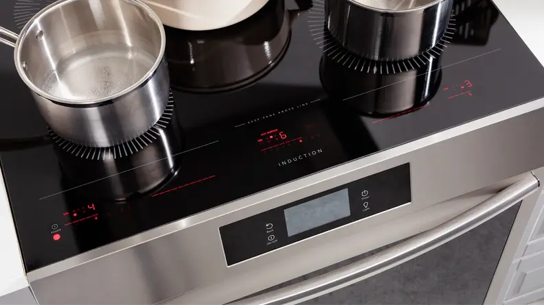 Aerial view of several stainless steel pots sitting on the cooktop of the Frigidaire Gallery GCFI3060BF 30-inch Induction Range.