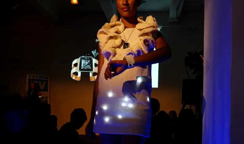CE Week: The model glances at her Zazzi smart cuff, which can digitally alter its appearance.