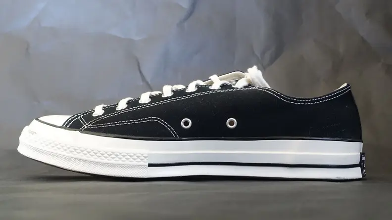 Black low top Chuck 70 sneaker side profile.