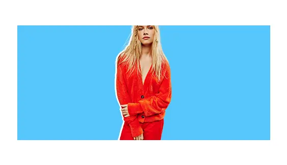 A model wearing a red cardigan.