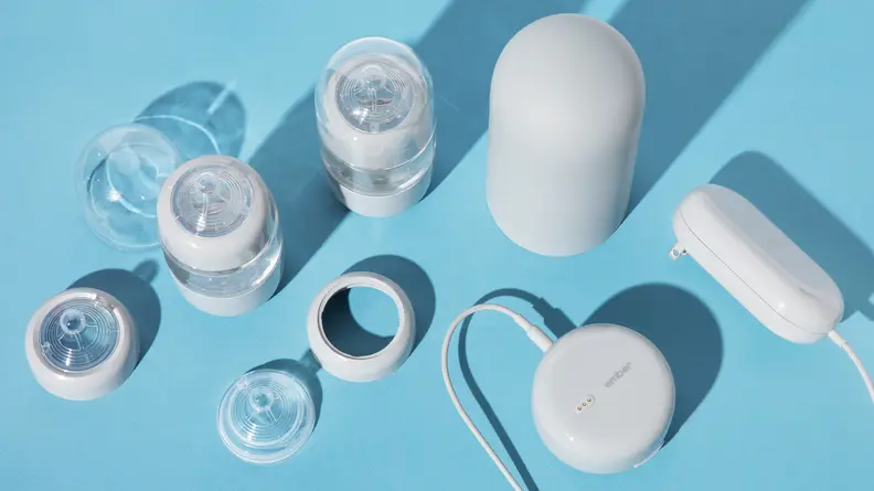 All the parts of the Baby Bottle System laid out on a blue background.