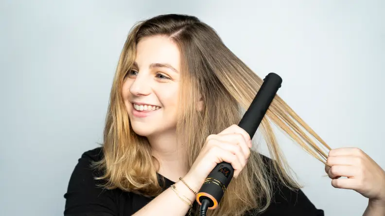 The author using the Hot Tools flat iron.