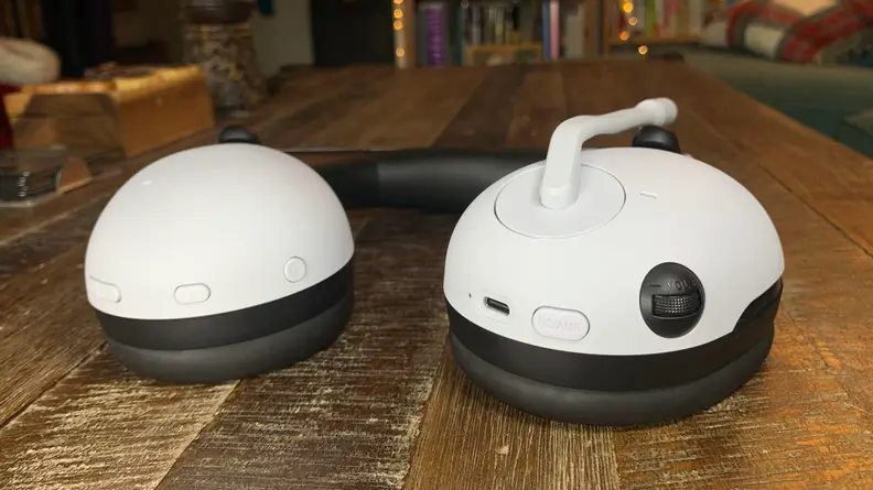 The buttons below the headphone pads.