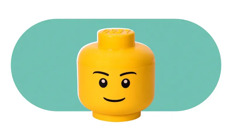A large, yellow, LEGO head that is also a storage bin for LEGOs.