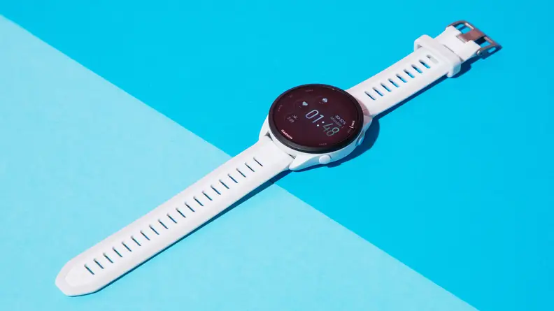The Garmin Forerunner 165 watch on a blue background.
