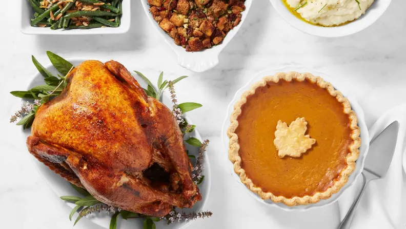 Thanksgiving turkey and pumpkin pie on a white table