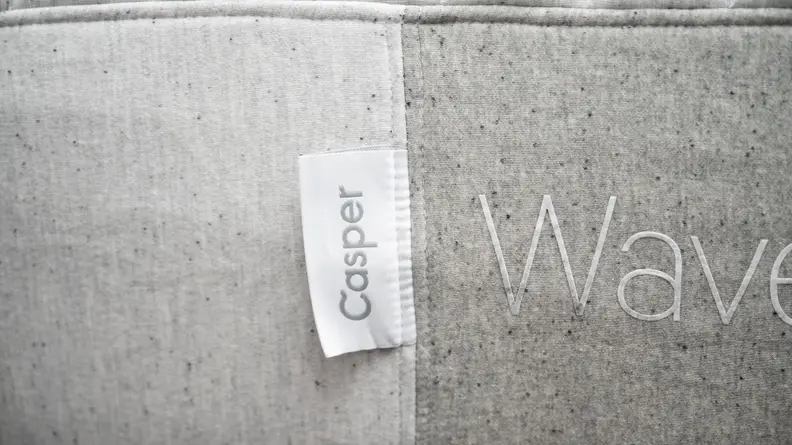 Side of a mattress with the Casper logo tag zoomed in