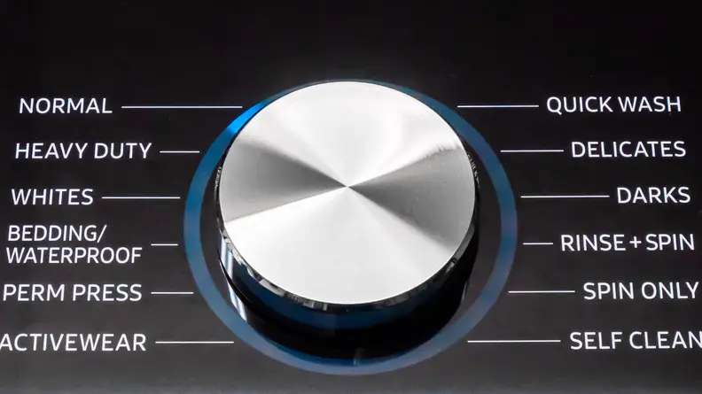 A close-up of the Samsung WA50R5400AV top-loading washing machine's control dial.
