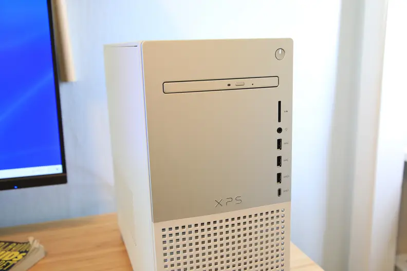 Close up of a DVD disc drive on a white Dell desktop computer tower.