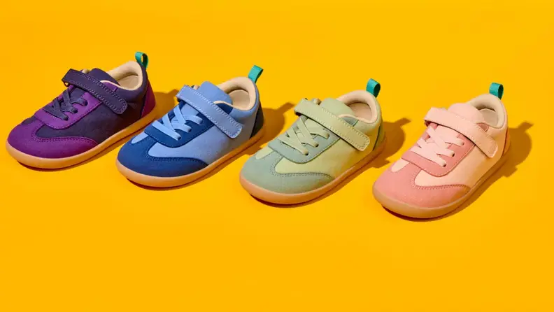 Yellow background with all 4 colors of retro suede sneaker (purple, blue, green pink)