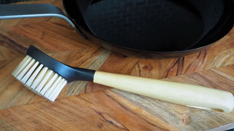 A Lodge cast-iron scrub brush can be used to clean carbon steel pans.