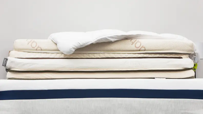 A stack of mattress toppers on top of a mattress.