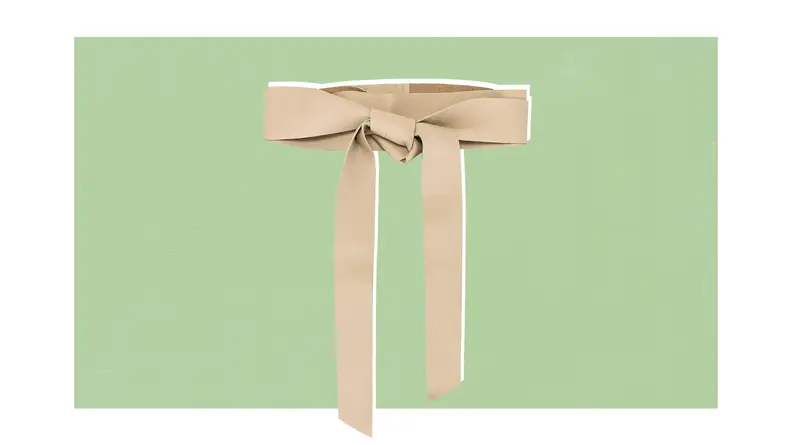 A cream-colored leather wrap belt that is knotted in the front.