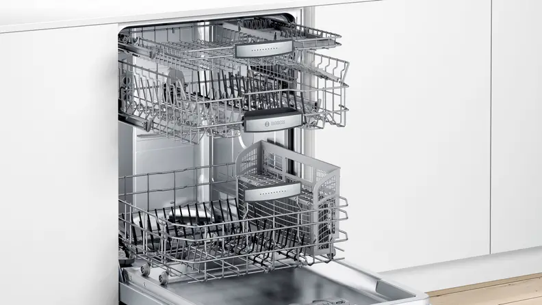 The Bosch SHPM88Z75N opened in a white kitchen.