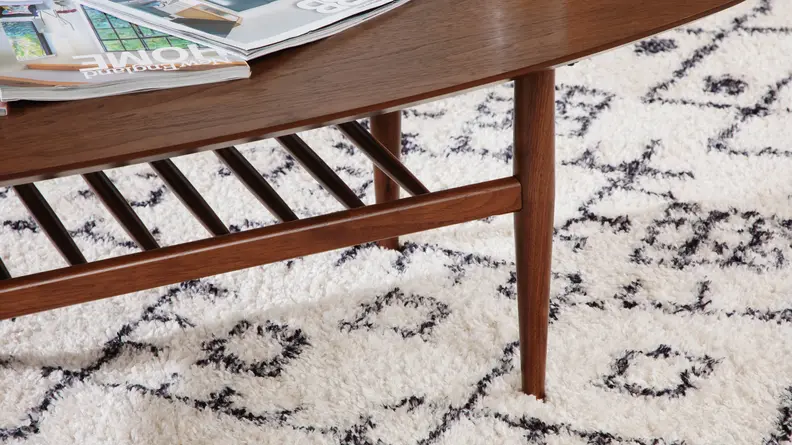 Close-up shot of the wooden legs on the Lenia Walnut Oval Coffee Table.