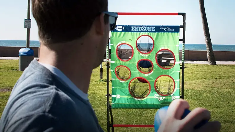 A person throws a sandbag into a goal.