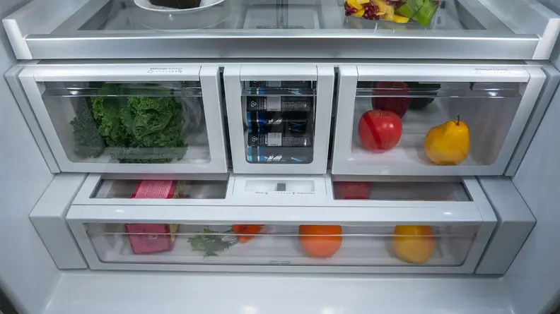 A close-up of the Whirlpool fridge compartment's lower half, showing its two crispers, beverage drawer, and full-width deli drawer.
