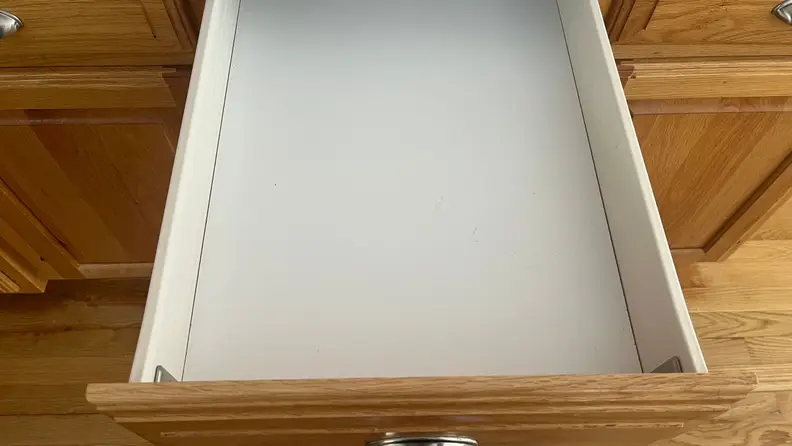 An empty drawer pulled open in the kitchen