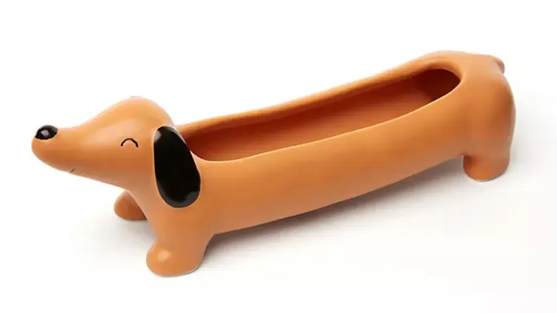 Brown dachsund shaped ceramic planter.