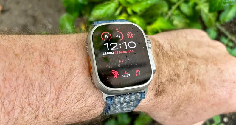 The Ultra 2 being worn by a dirty-looking explorer. It's face is visible under direct sunlight.