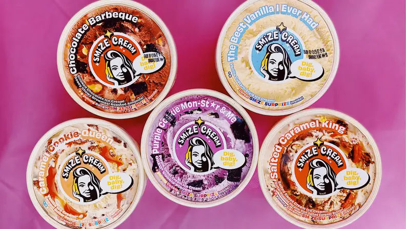 Five Smize Cream containers seen from above against a pink background.