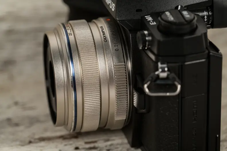 The 17mm f/1.8 is compact enough for travel and sharp enough for most purposes, but it's on the expensive side compared to similar lenses.
