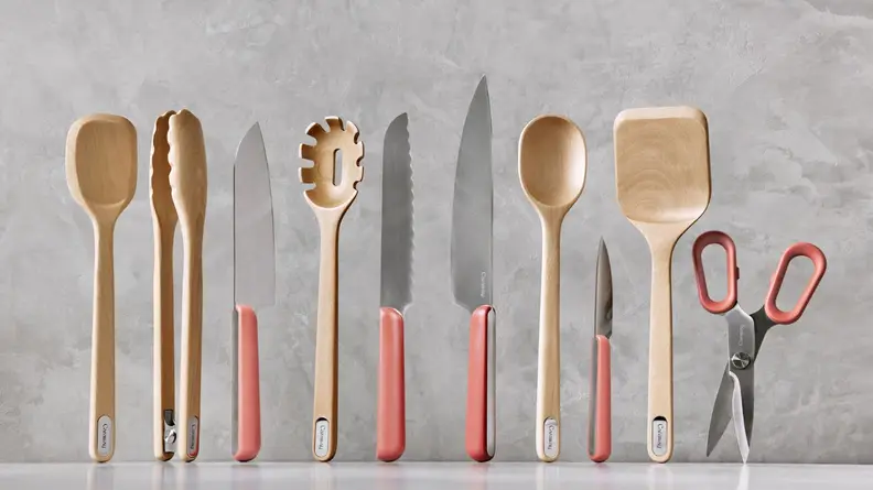 Assorted kitchen tools including spoons, tongs, scissors, knives and a spatula.